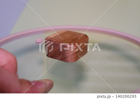 Wooden Cube Floating on Glass Surface 140200293