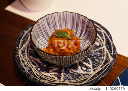 Artisanal Dish in Ceramic Bowl on Decorative Plate Artisanal Dish in Ceramic Bowl on Decorative Plate 140200559