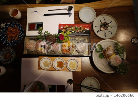 Elegant Japanese Kaiseki Meal Spread on Wooden Table Elegant Japanese Kaiseki Meal Spread on Wooden Table 140200560
