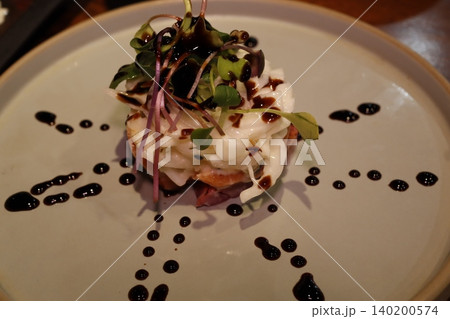 Gourmet Dish with Creamy Topping and Microgreens Gourmet Dish with Creamy Topping and Microgreens 140200574