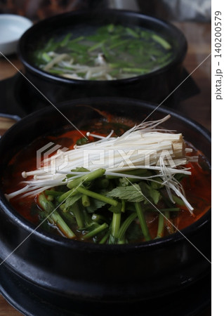 Hot Pot with Mushrooms and Greens in Black Pots 140200579