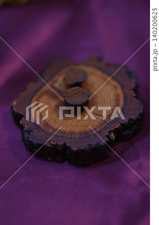 Wood Cross-Section with Growth Rings and Pegs on Purple Fabric Wood Cross-Section with Growth Rings and Pegs on Purple Fabric 140200625