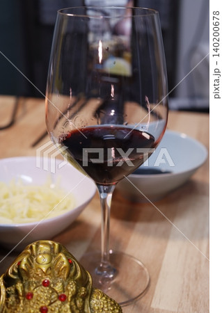 Wine Glass with Red Wine and Cheese Bowl Close-up 140200678