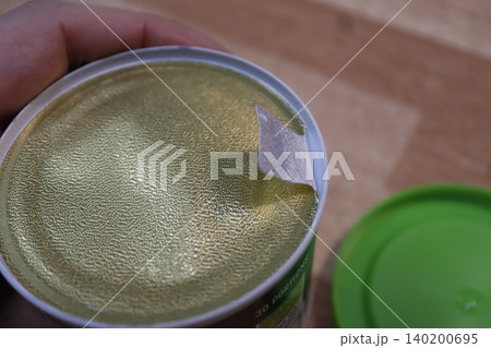 Close-up of a Can with Golden Interior and Hand Holding Close-up of a Can with Golden Interior and Hand Holding 140200695