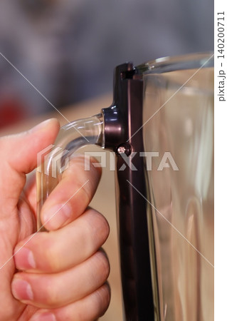 Hand Gripping Transparent Handle of Glass Container Hand Gripping Transparent Handle of Glass Container 140200711