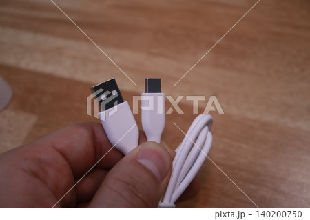 USB Cable with A and C Connectors Held in Hand 140200750