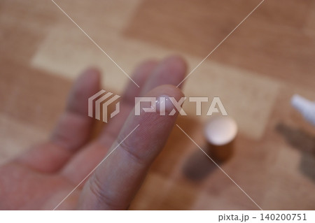 Close-up of Finger with Small White Spot on Nail 140200751
