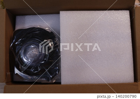 Camera Lens in Cardboard Box with Foam Padding Camera Lens in Cardboard Box with Foam Padding 140200790