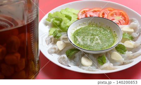 shrimp in fish sauce with Thai spicy seafood dipping sauce on white plate and umeshu shrimp in fish sauce with Thai spicy seafood dipping sauce on white plate and umeshu 140200853