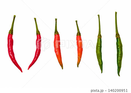 red orange and green chilies in white back ground red orange and green chilies in white back ground 140200951