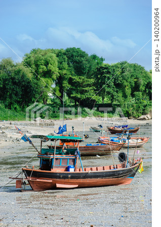 many empty Thai fishing boats lay down on a sea base 140200964
