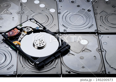 a shot of one hard drive that remove cover out to show magnetic disc inside and put it on many hdd 140200973
