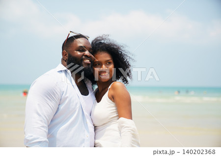 Romantic Black couple enjoying tropical holiday together by the sea 140202368