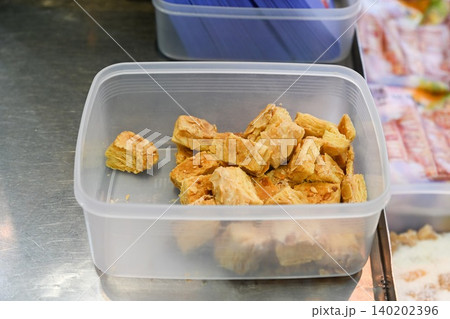 Traditional Chinese crunchy almond puff pastry cookies inside plastic container box at local street food bakery shop counter display in Taipa Macau 140202396