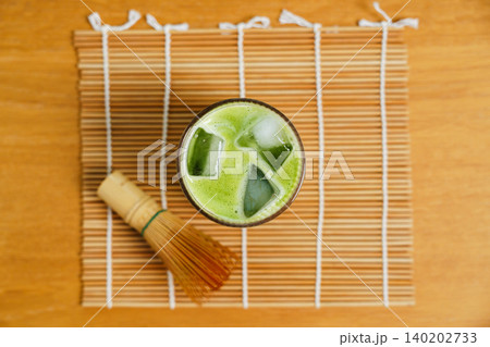Top view of iced matcha green tea in glass on bamboo mat Top view of iced matcha green tea in glass on bamboo mat 140202733