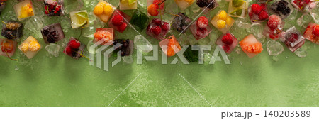 Green background with ice cubes with frozen berries and fruits and mint, banner Green background with ice cubes with frozen berries and fruits and mint, banner 140203589