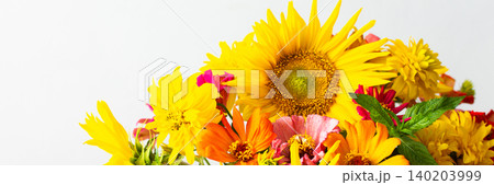 Flowers in a vase fill a space with color and texture. Sunflowers, zinnias, and greenery are mixed together. Light brightens the scene, showcasing their vibrant colors, banner Flowers in a vase fill a space with color and texture. Sunflowers, zinnias, and greenery are mixed together. Light brightens the scene, showcasing their vibrant colors, banner 140203999