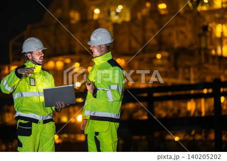 Professional Engineer Team Working at Refinery plant background twilight evening. Oil Gas Energy man 140205202