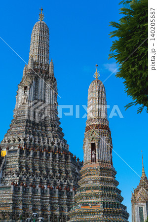 Wat arun temple dawn bangkok chao phraya river tower spire under blue sky with ornate calm historic architecture Wat arun temple dawn bangkok chao phraya river tower spire under blue sky with ornate calm historic architecture 140205687