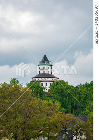 Humprecht Castle in Sobotka, Cesky Raj, rises above forests and fields under dramatic dark clouds. Baroque tower-like shape 17th century hunting lodge now museum and concert hall Humprecht Castle in Sobotka, Cesky Raj, rises above forests and fields under dramatic dark clouds. Baroque tower-like shape 17th century hunting lodge now museum and concert hall 140205697