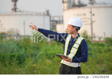 Worker inspecting industrial site oil refinery professional image outdoor environment side view safety and oversight Worker inspecting industrial site oil refinery professional image outdoor environment side view safety and oversight 140206846