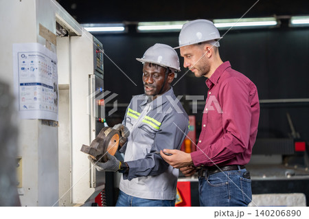 Collaborative equipment setup manufacturing facility instructional interaction industrial environment close-up view workplace safety Collaborative equipment setup manufacturing facility instructional interaction industrial environment close-up view workplace safety 140206890