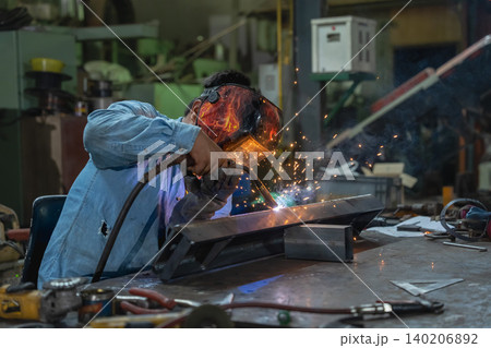 Welding action in workshop metal fabrication scene industrial environment close-up view skilled craftsmanship Welding action in workshop metal fabrication scene industrial environment close-up view skilled craftsmanship 140206892