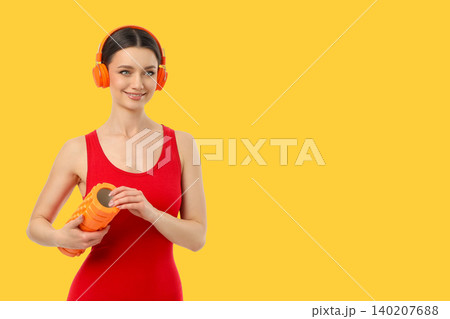 Yoga session with fitness gear and headphones in bright space Yoga session with fitness gear and headphones in bright space 140207688