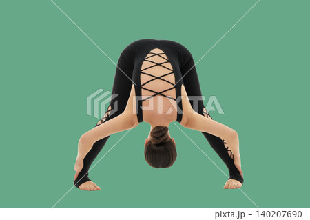 Yoga practice showing a woman stretching in a studio space Yoga practice showing a woman stretching in a studio space 140207690