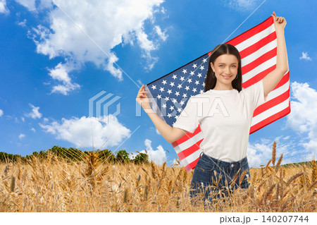 USA 250, Woman waves American flag in vibrant wheat field. Patriotism and freedom concept 140207744