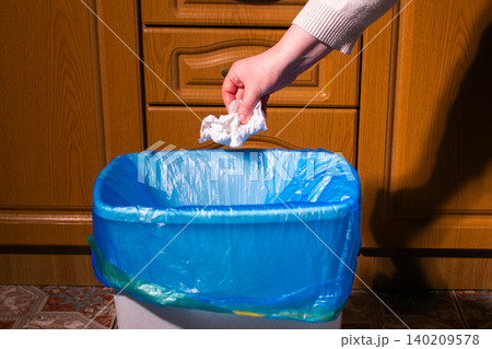 Woman putting paper in waste bin, separate waste collection and recycling concept Woman putting paper in waste bin, separate waste collection and recycling concept 140209578