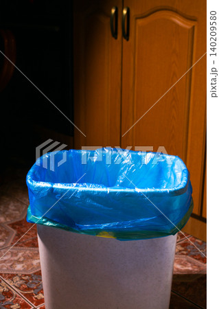Empty trash bin with blue garbage bag on home kitchen Empty trash bin with blue garbage bag on home kitchen 140209580