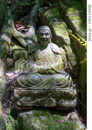 Monk statue in serene Mitaki-Dera temple garden in Hiroshima Monk statue in serene Mitaki-Dera temple garden in Hiroshima 140210006