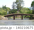 岡山県津山市にある回遊式日本庭園「衆楽園」：土橋を渡る子供連れ 140210675