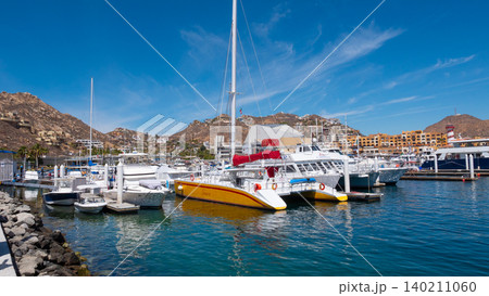 Cabo San Lucas, Mexico - May 15, 2019: Vacation on summer. Catamaran at sea marina. Sea travel. Catamaran sailing in sea. Luxury catamaran yacht in bay. Summer vacation. Luxury travel life Cabo San Lucas, Mexico - May 15, 2019: Vacation on summer. Catamaran at sea marina. Sea travel. Catamaran sailing in sea. Luxury catamaran yacht in bay. Summer vacation. Luxury travel life 140211060