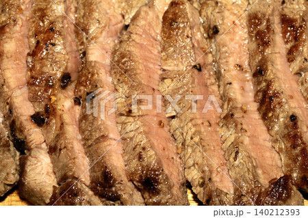 Close up of sliced fried steak beef meat perfectly cooked and succulent Close up of sliced fried steak beef meat perfectly cooked and succulent 140212393