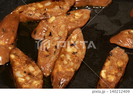 Close up of chorizo sliced cooking frying food preparation for meal Close up of chorizo sliced cooking frying food preparation for meal 140212409
