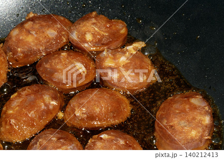 Close up of chorizo sliced cooking frying food preparation for meal 140212413