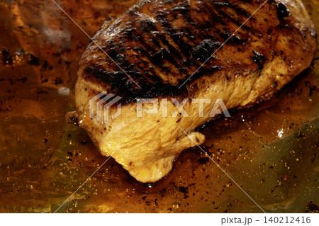 Roast chicken breast smothered in glaze and oils 140212416