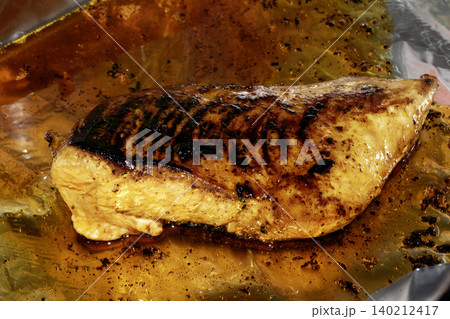 Roast chicken breast smothered in glaze and oils 140212417