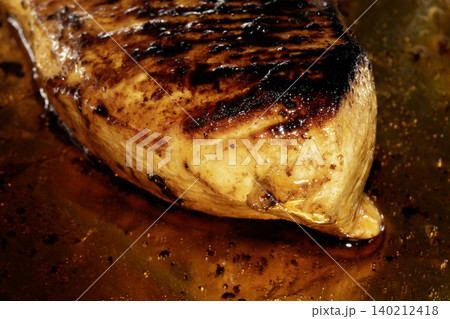 Roast chicken breast smothered in glaze and oils 140212418
