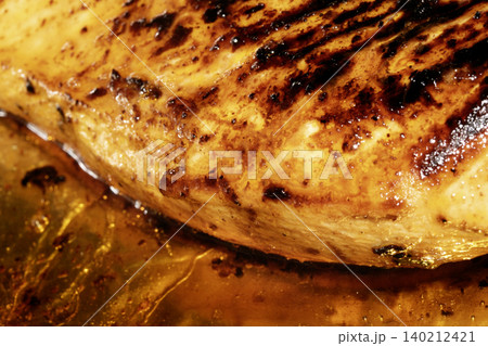Roast chicken breast smothered in glaze and oils Roast chicken breast smothered in glaze and oils 140212421