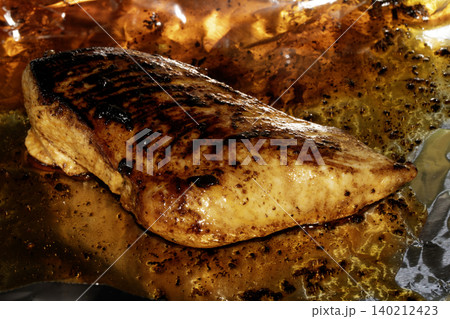 Roast chicken breast smothered in glaze and oils 140212423