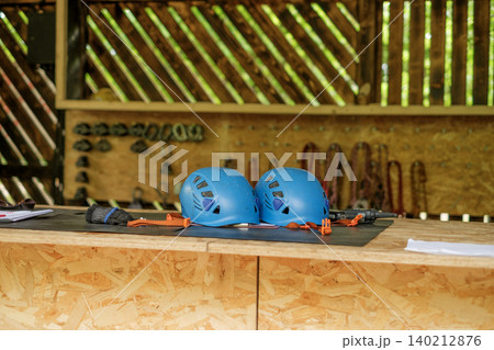 Protective sports helmets at reception desk at climbing amusement park Protective sports helmets at reception desk at climbing amusement park 140212876