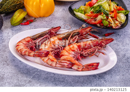 Grilled giant red prawns on white plate with fresh salad and vegetables Grilled giant red prawns on white plate with fresh salad and vegetables 140213125