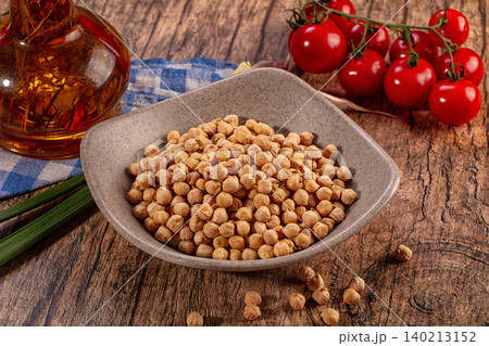 Healthy chickpeas bowl, vibrant cherry tomatoes, oil bottle, green onions on rustic wood Healthy chickpeas bowl, vibrant cherry tomatoes, oil bottle, green onions on rustic wood 140213152
