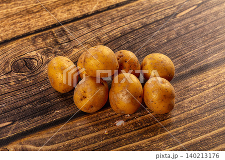 Fresh Raw Unpeeled Potatoes on Rustic Dark Wood Table Fresh Raw Unpeeled Potatoes on Rustic Dark Wood Table 140213176