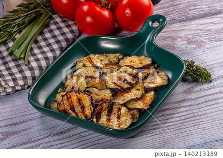 Grilled eggplant slices in green dish with fresh tomatoes and herbs Grilled eggplant slices in green dish with fresh tomatoes and herbs 140213189