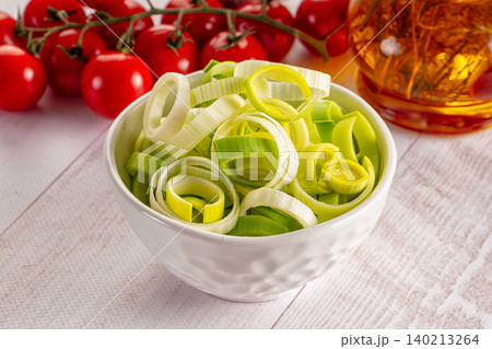 Sliced fresh green leeks in bowl with tomatoes Sliced fresh green leeks in bowl with tomatoes 140213264
