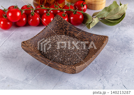 Chia seeds in wooden bowl with tomatoes and bay leaves Chia seeds in wooden bowl with tomatoes and bay leaves 140213287
